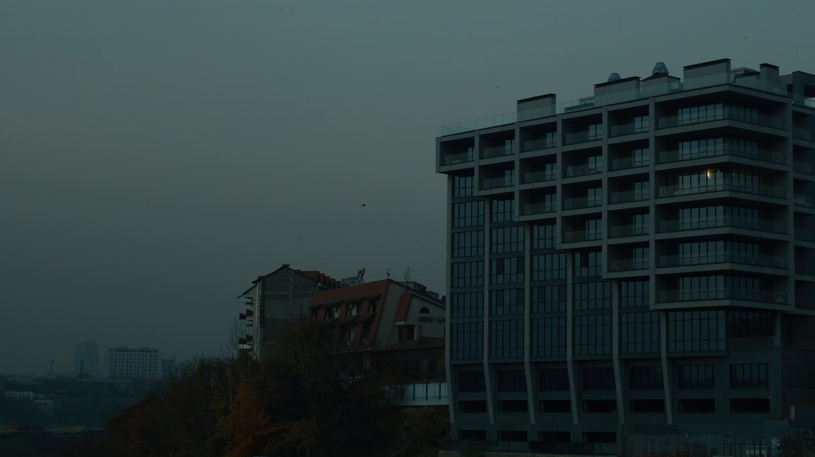 Modern building against a dark, overcast sky