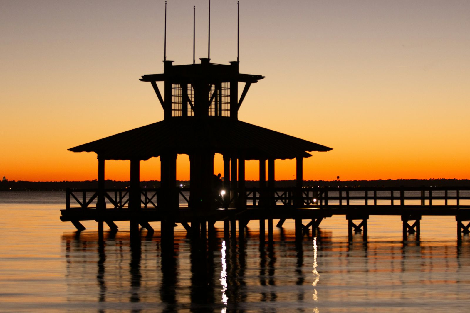 Silhouette of a pier pavilion at sunset