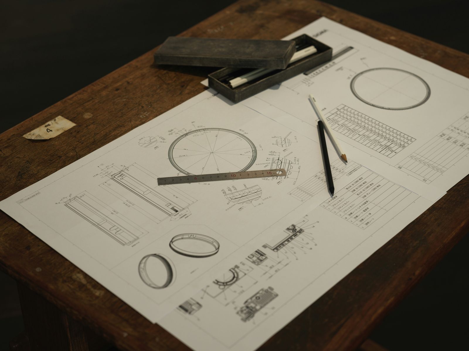 A wooden table topped with a piece of paper and a pair of scissors
